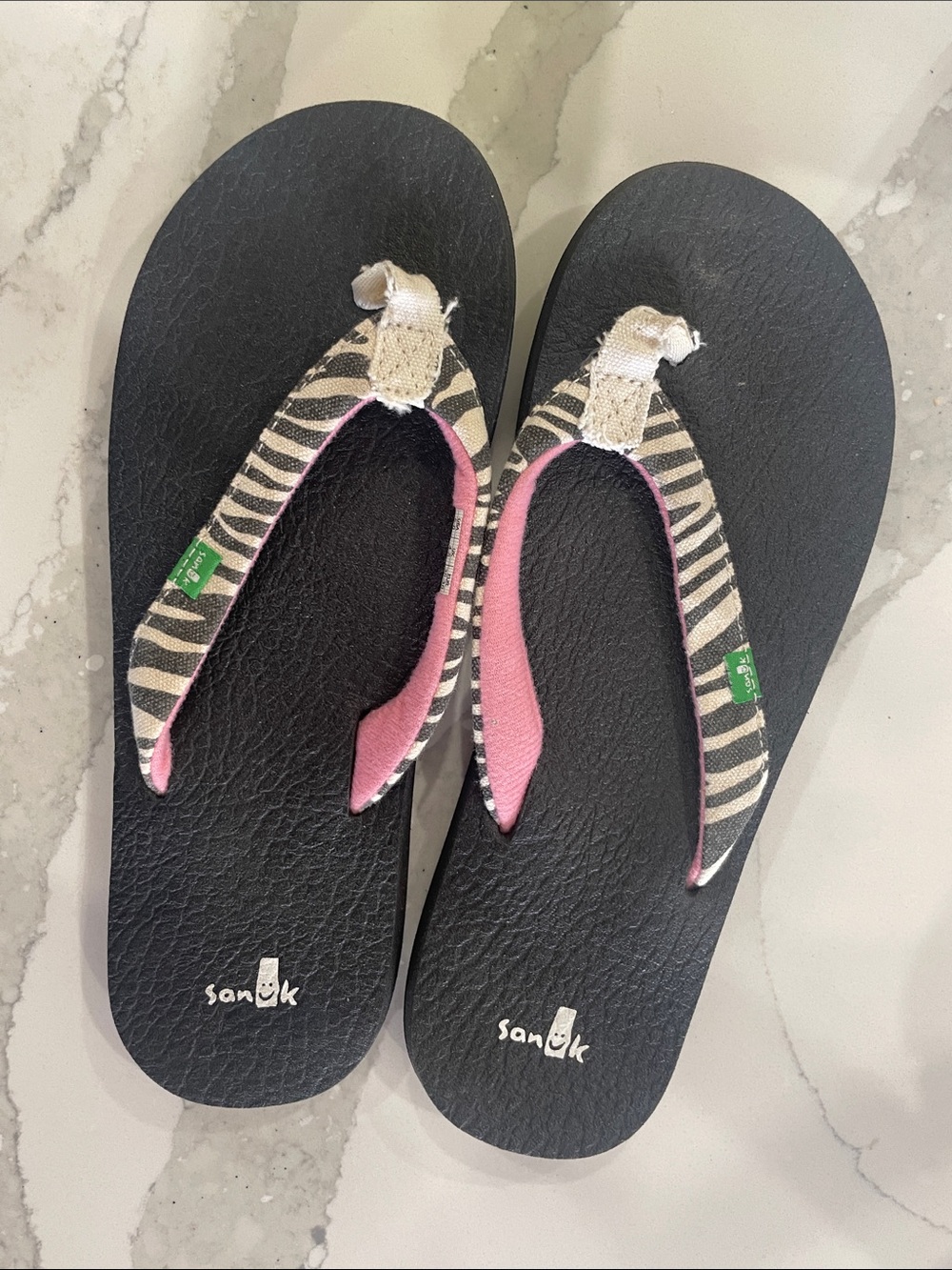 Sanuk Black Flip Flops with Zebra Striped Straps and Pink Accents